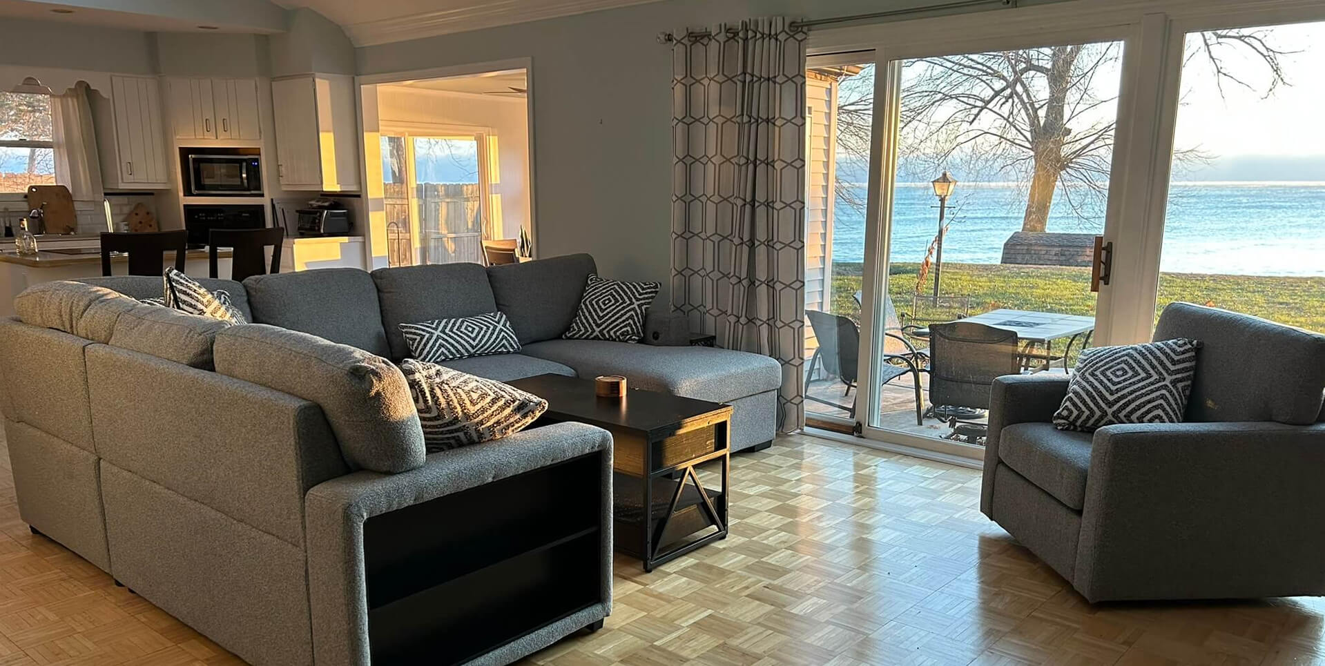 Open Concept Living Room with Large Windows Over Looking the Lake